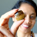 sheila of satin crystals holding faceted tigers eye diamond cut cabochon