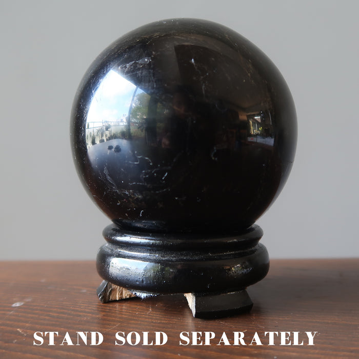 black tourmaline sphere on wood display stand which is sold separately