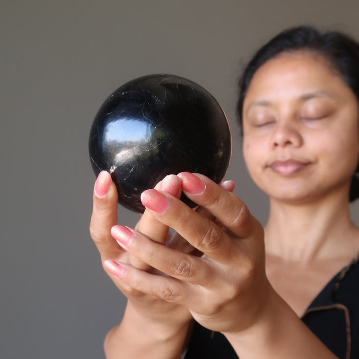 sheila of satin crystals mediating with a black tourmaline sphere