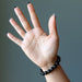 hand wearing black tourmaline round stretch bracelet