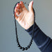 hand holding gradual Black Tourmaline round bead Necklace 