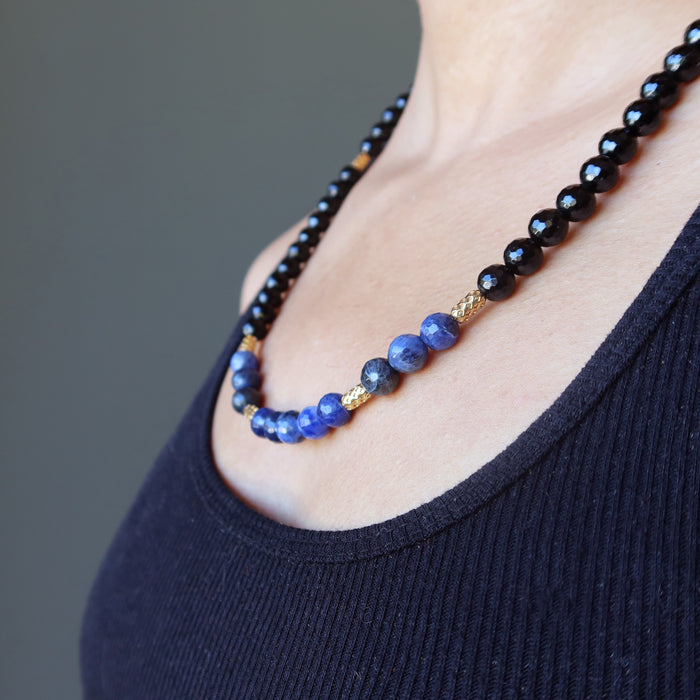 faceted black tourmaline and blue sodalite necklace on neck