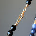 gold lobster claw clasp of  faceted black tourmaline and blue sodalite necklace
