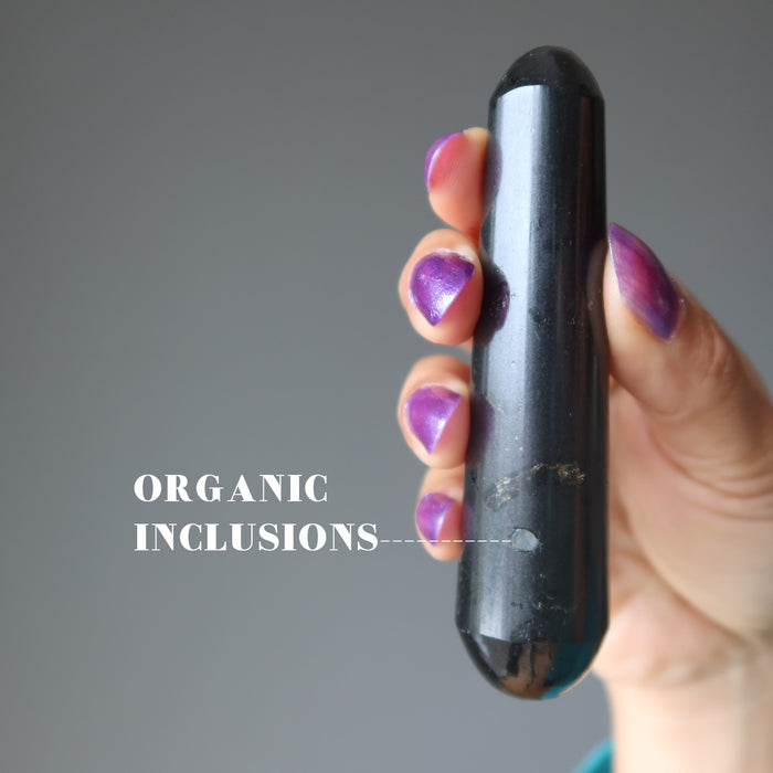 hand holding Black Tourmaline Massage Wand showing organic inclusions