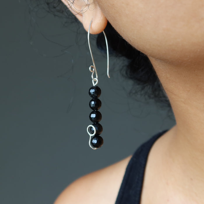 faceted black tourmaline earrings on ear