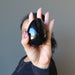 hand holding black tourmaline egg
