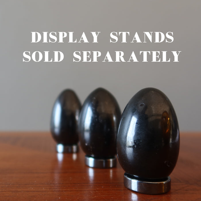 three black tourmaline eggs on display stands which are sold separately