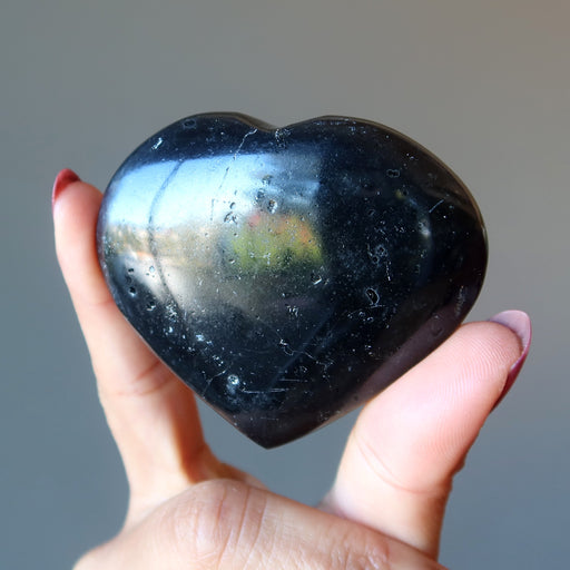 black tourmaline heart in hand