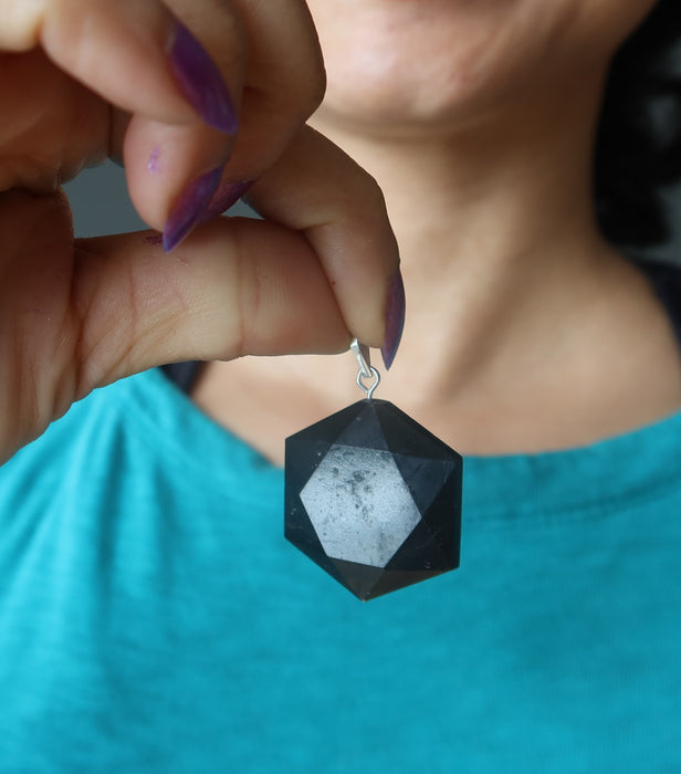 black tourmaline hexagon pendant at chest