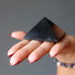 black tourmaline pyramid on palm 