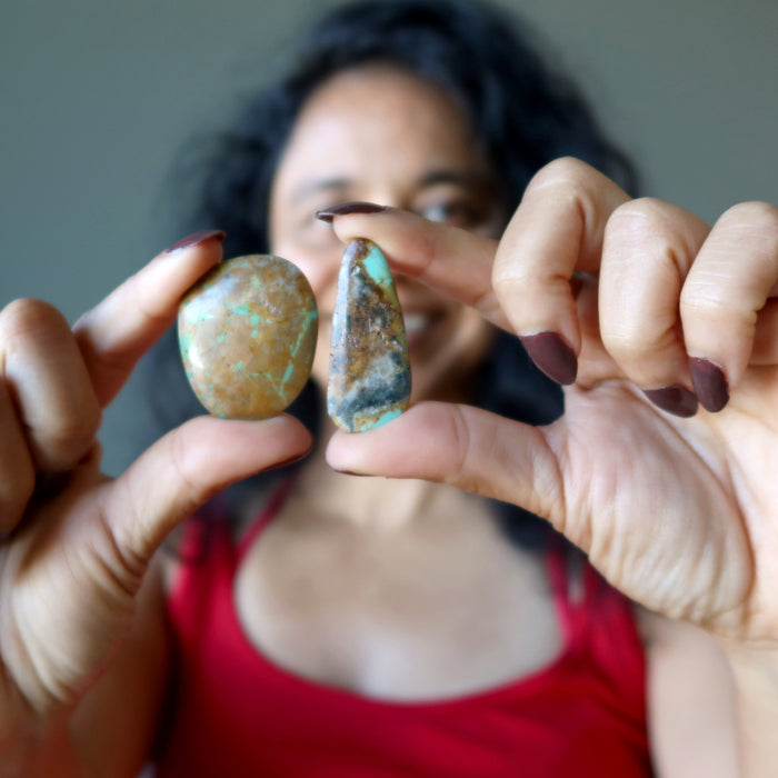 sheila holding  2 Turquoise Polished Stones both hands