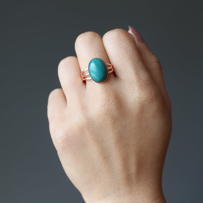 hand wearing a turquoise copper ring