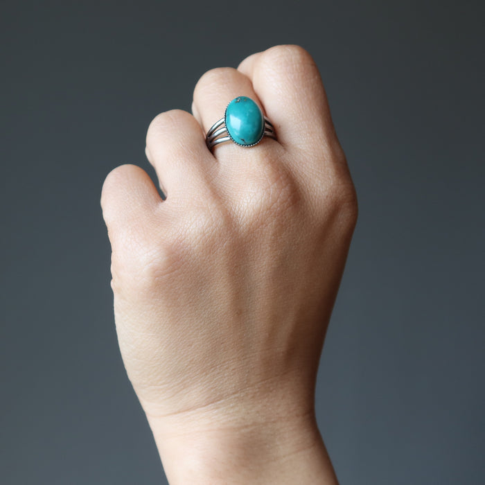 hand wearing turquoise ring