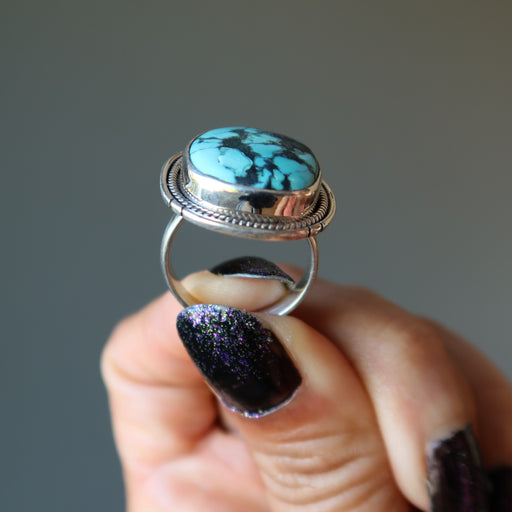hand holding turquoise sterling silver ring