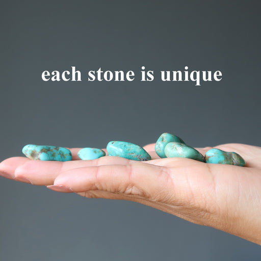tumbled turquoise stones in hand