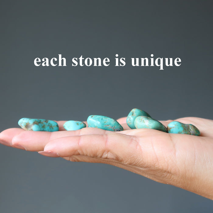 tumbled turquoise stones in hand
