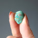 tumbled turquoise stone in hand