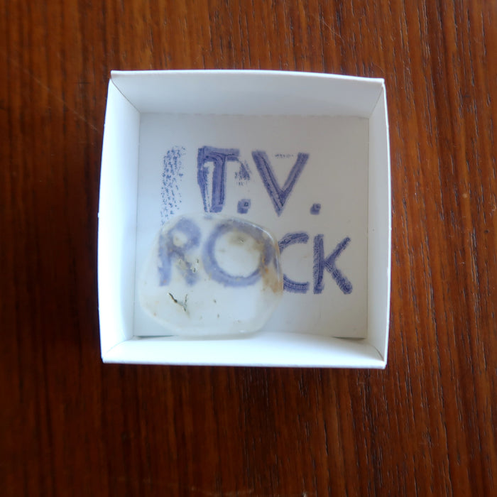 Ulexite TV stone in a white box