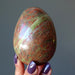 fingers holding Pink Green Unakite Egg