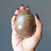 hand holding Pink Green Unakite Egg