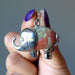 finger tips holding Unakite elephant pendant