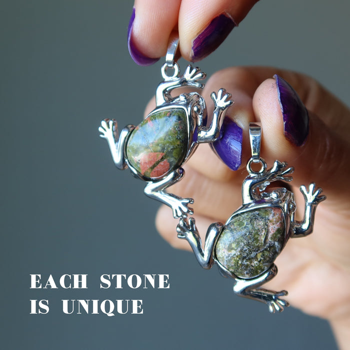 hands holding two partly silver and Unakite frog Pendants