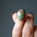 hand holding unakite copper ring