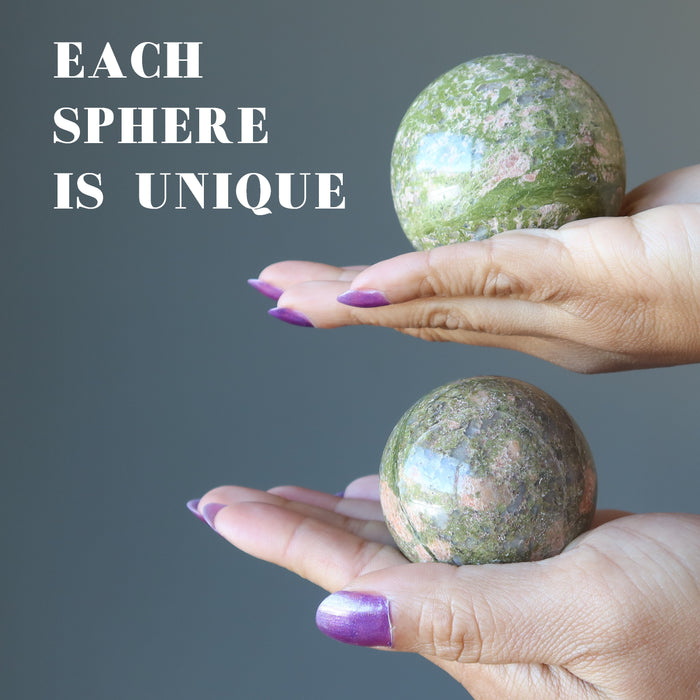 two hands holding unakite spheres to show each is unique