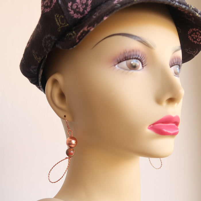 mannequin wearing Twist Copper Loops Unakite Earrings